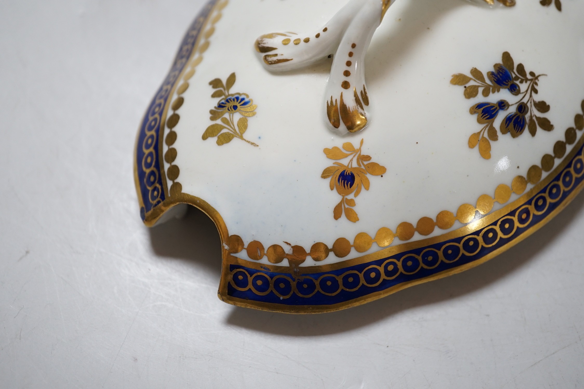 An 18th century Caughley tureen cover and stand with blue and gilt decoration, stand mis-fired to border, S mark to stand and base. 15cm wide